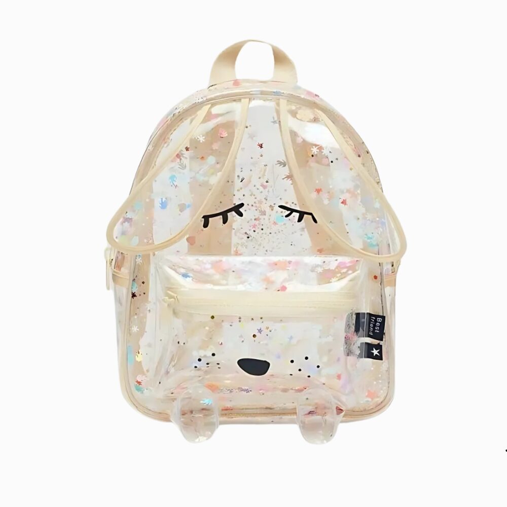Cartable paillette transparent aux coutures beiges, avec des longues oreilles qui dépassent et des petites pattes sur le bas. Des yeux fermés de style kawaii se trouvent sur le devant du sac. Sur fond gris clair.