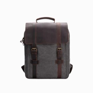 Cartable sac à dos vintage gris en toile et cuir sur fond blanc