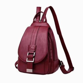 Cartable en similicuir bordeaux élégant pour femme avec bretelles zippées pour en faire une bandoulière. Sur fond gris clair.