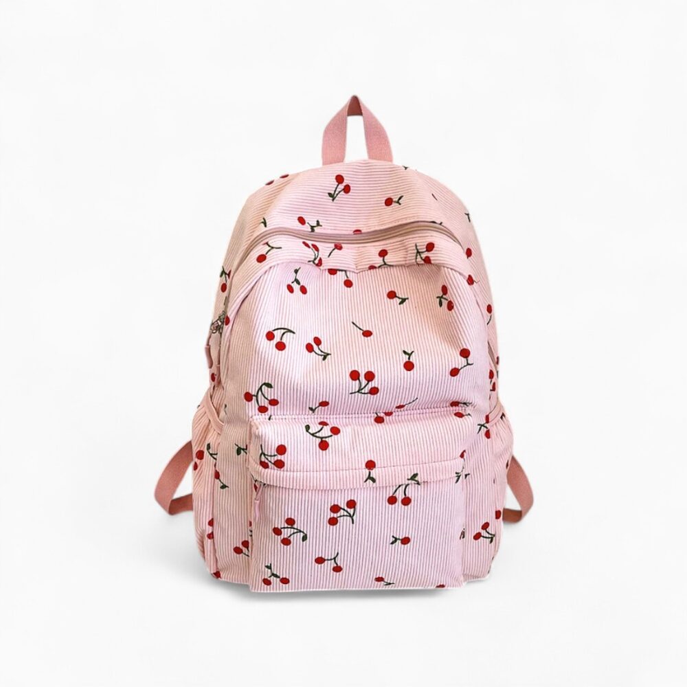 cartable rose clair à motif cerises, en tissu velours côtelé, sur fond neutre
