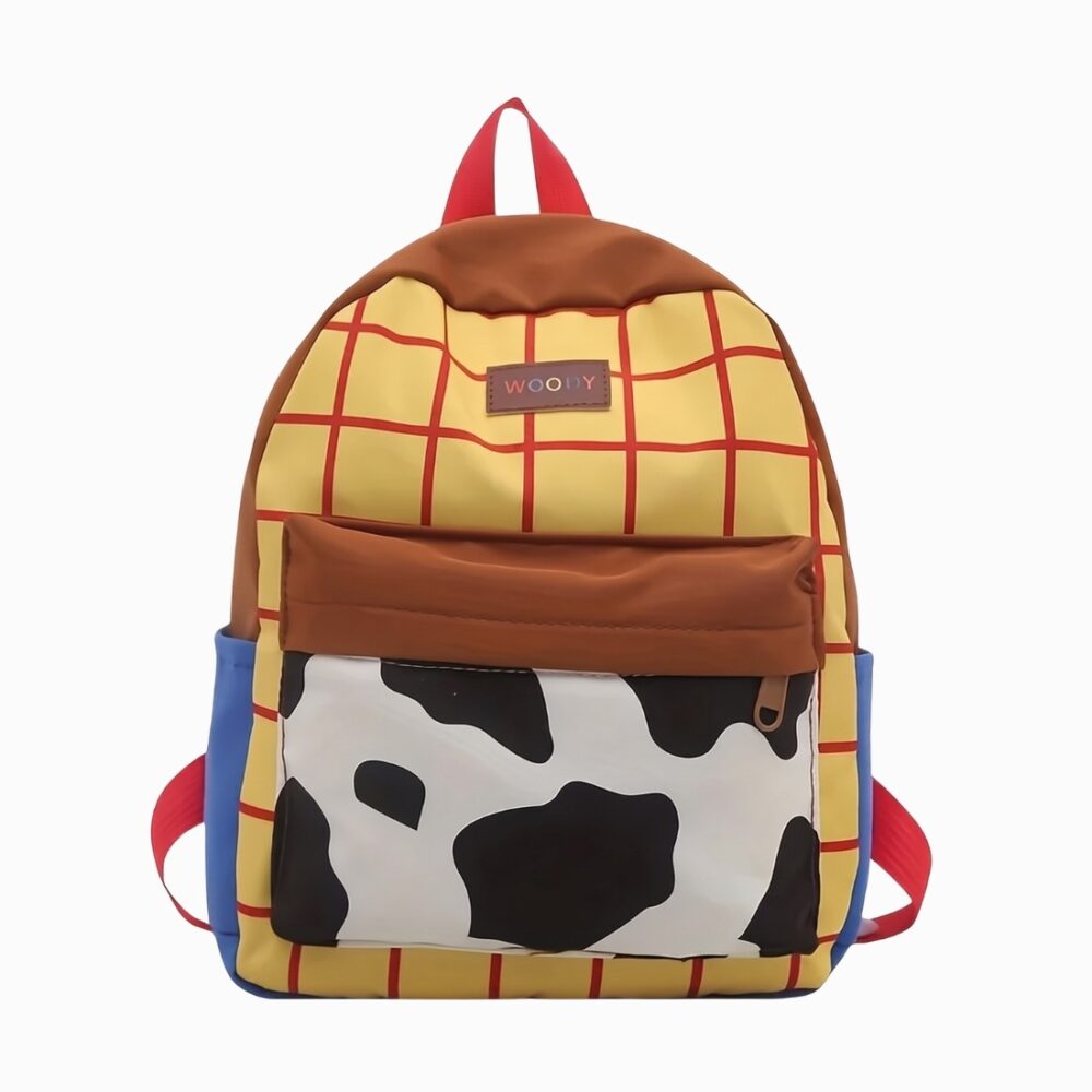 Un cartable Toy Story pour maternelle aux couleurs de Woody, avec un fond jaune à carreaux rouges, une poche blanche et noire façon vache, et des bretelles rouges.