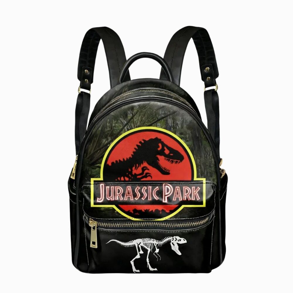 Un cartable Jurassic Park aspect vintage simili-cuir noir, avec un grand logo de dinosaure rouge et jaune et une petite silhouette de squelette en bas, posé sur fond blanc.